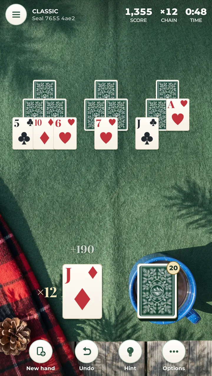 A hand in play on dark green felt: three peaks of cards, a chain in progress beside the open card, the stock with its card count, and the Undo and Hint buttons
