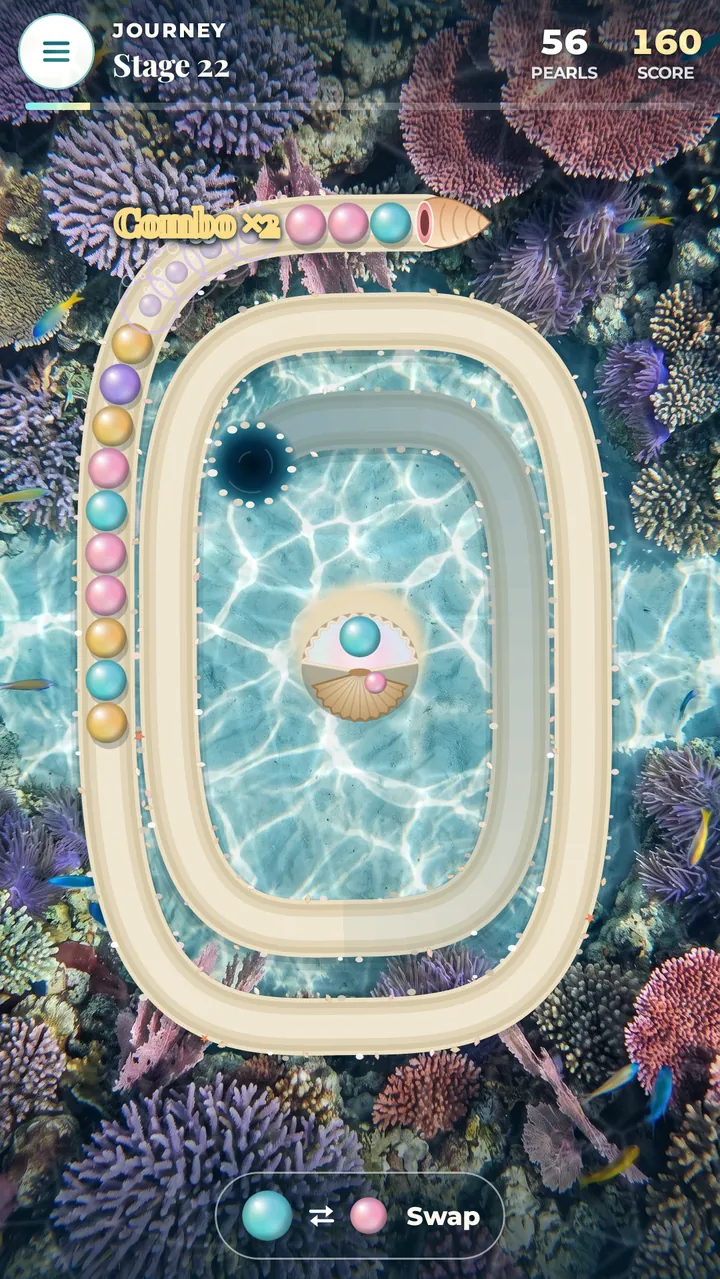 A combo on the Coral Garden reef: a gap closes, matching pearls pop in a burst of bubbles and the text Combo ×2 floats above the chain